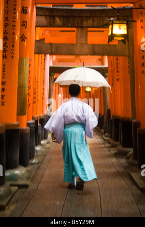 Shinto monk in Fushimi Inari Taisha in Japan Stock Photo