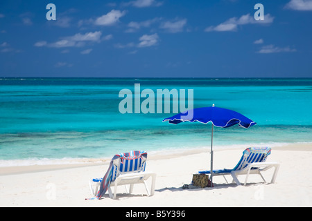 Chairs and umbellas on Shoal Bay East Beach on the caribbean island of Anguilla in the British West Indies Stock Photo