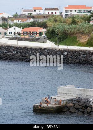 Children fishing in the sea at the small village Mosteiros, São Miguel, Azores, Portugal Stock Photo