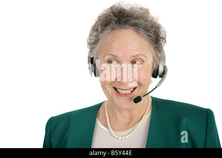 A pretty senior woman volunteering on a phone bank or offering technical support Isolated on white Stock Photo