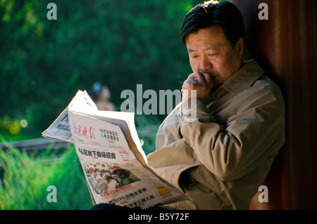 Man reading his newspaper Beijing China Stock Photo