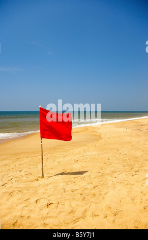 Red Danger Flag at Candolim Beach, Goa, India Stock Photo