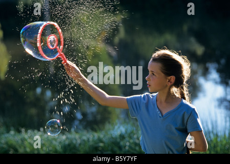 Girl with bubble maker wand Stock Photo