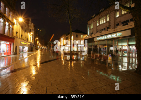 City of Cardiff, South Wales. Rainey night view of Cardiff city centre Queen Street shopping precinct. Stock Photo