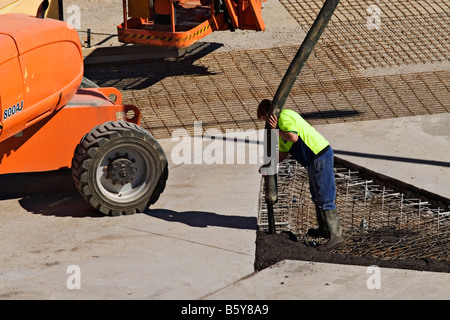 Construction / A Construction worker pours Cement on a Building Site.Melbourne Victoria Australia. Stock Photo