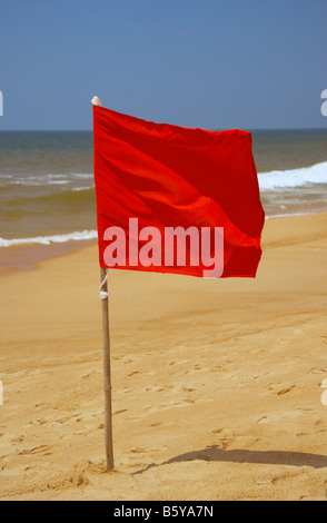 Red Danger Flag at Candolim Beach, Goa, India Stock Photo