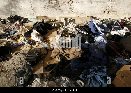 pile of old clothes garments left on street road Stock Photo