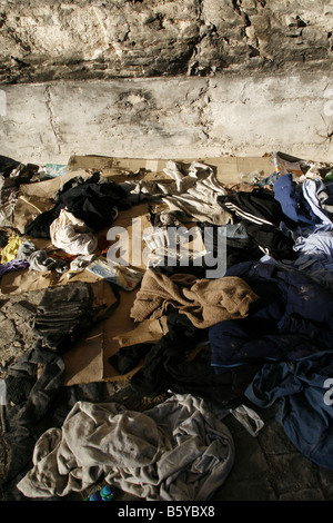 pile of old clothes garments left on street road Stock Photo