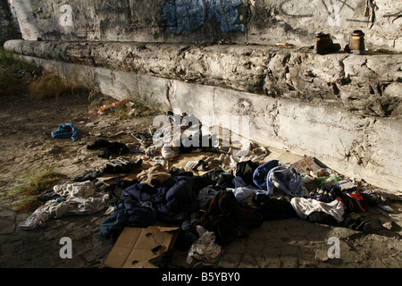 pile of old clothes garments left on street road Stock Photo