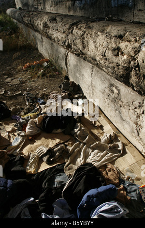 pile of old clothes garments left on street road Stock Photo