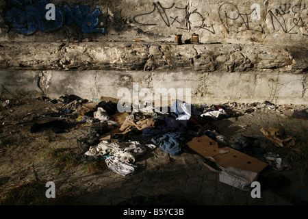 pile of old clothes garments left on street road Stock Photo