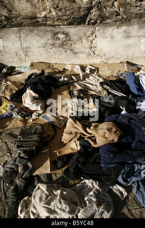 pile of old clothes garments left on street road Stock Photo