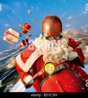 Santa Claus riding scooter Stock Photo