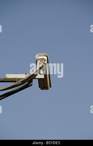 one cctv camera on high pole outdoors in sun Stock Photo