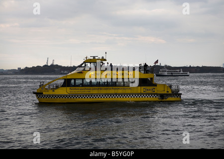 Water taxi on the Hudson River near Battery Park, Manhattan, New York City USA Stock Photo