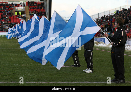Young flag bearers waving Scottish Saltire flags at a national rugby match at Pittodrie Stadium, Aberdeen, Scotland, uk Stock Photo