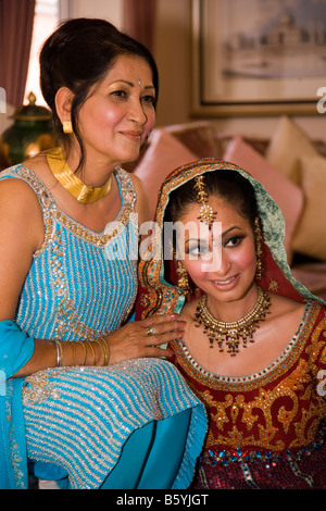 Sikh woman with mother getting ready for her marriage ceremony in temple or gurdwara uk Stock Photo