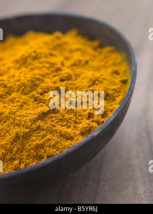 Dish of Ground Dried Turmeric Stock Photo