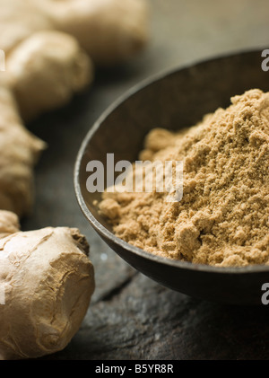 Dish of Ginger Powder with Fresh Ginger Root Stock Photo