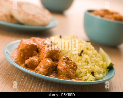 Plated Chicken Korma with Pilau Rice and Naan bread Stock Photo