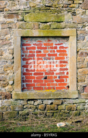A bricked up window in an old house Stock Photo