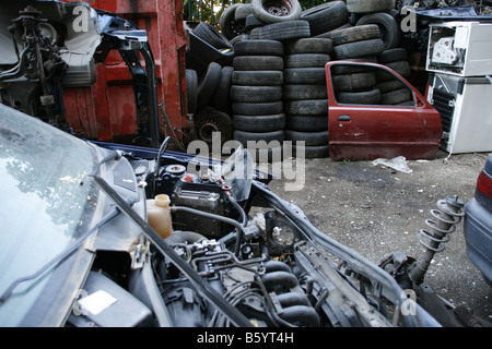 piled up spare parts and cars in breakers scrap yard Stock Photo