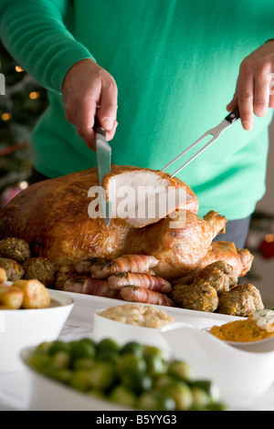 Carving Christmas Roast Turkey with all the Trimmings Stock Photo