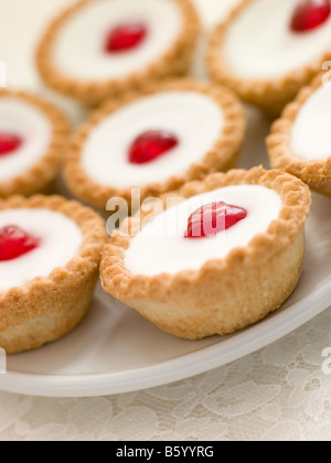 Plate of Cherry Bakewell Tarts Stock Photo