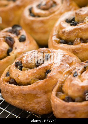 Chelsea Buns on a cooling rack Stock Photo