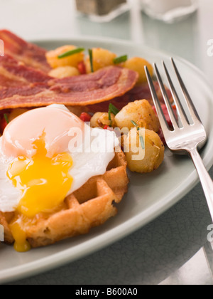 Waffles with Bacon Fried Potatoes and a Broken fried Egg Stock Photo