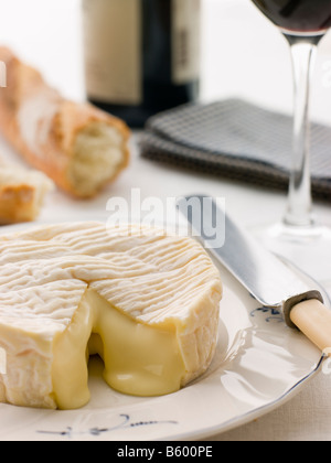 Round of camembert cheese with French stick and Red Wine Stock Photo