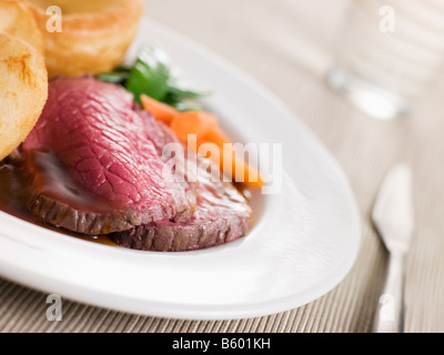 Roast Topside of British Beef with Yorkshire Pudding and Vegetables Stock Photo