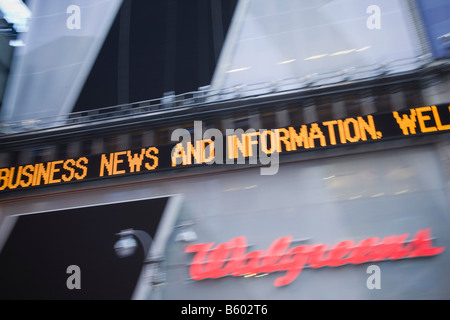Business news and information appears on the Dow Jones news ticker at 1 Times Square in New York USA November 2008 Stock Photo