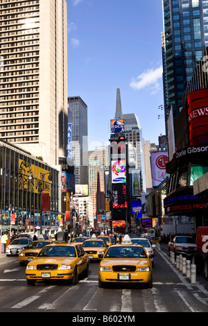 Yellow cabs drive through Times Square in New York USA November 2008 Stock Photo