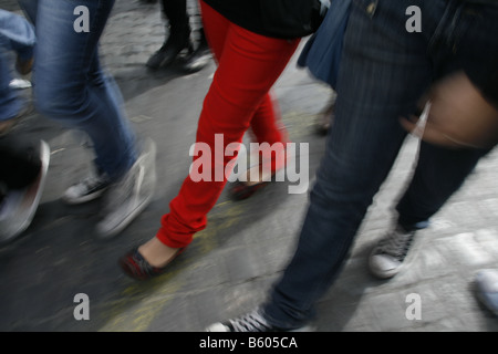 group young people in denim jeans walking in town Stock Photo