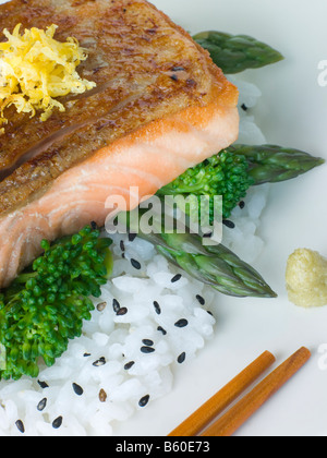 Citrus Salmon Fillet on Rice Steamed Vegetables with Sesame and Wasabi Stock Photo