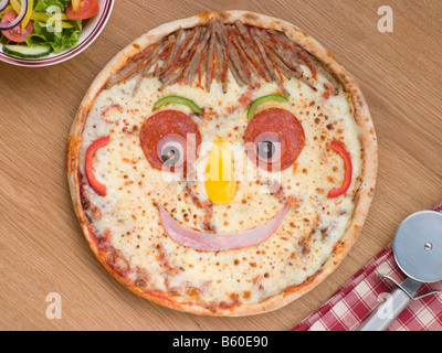 Smiley Faced Pizza with a Side Salad Stock Photo