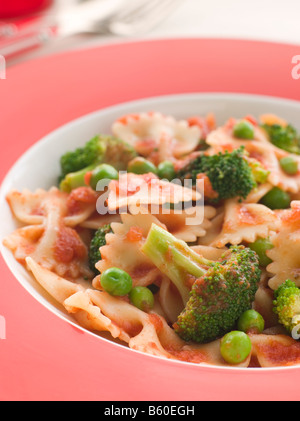 Pasta Bows with Tomato Sauce Broccoli and Peas Stock Photo
