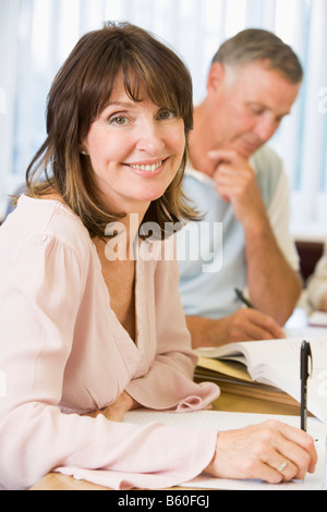 Adult students studying at table (selective focus) Stock Photo