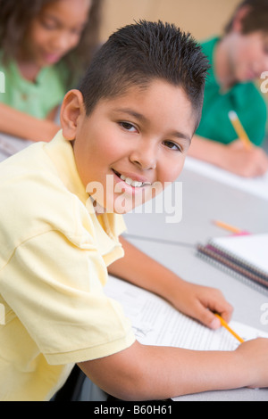 Student in class taking notes (selective focus) Stock Photo
