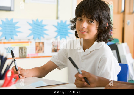 Student in class taking notes Stock Photo