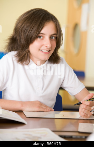 Student in class taking notes Stock Photo