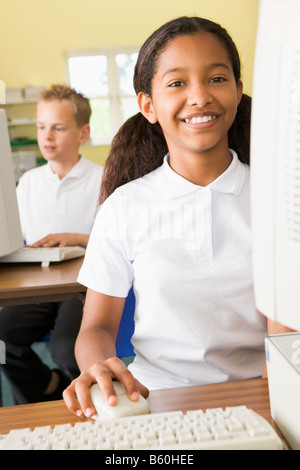 Student at computer terminal with student in background (selective focus) Stock Photo