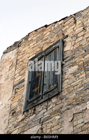 Brick house wall with closed shutters in Lefkara Stock Photo