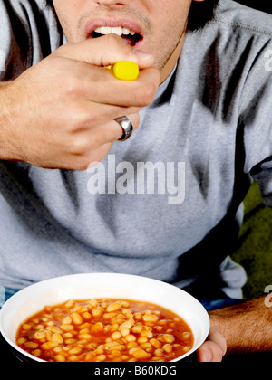 Young Man Eating Baked Beans Model Released Stock Photo