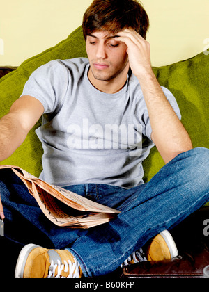 Young Man Reading Newspaper Model Released Stock Photo