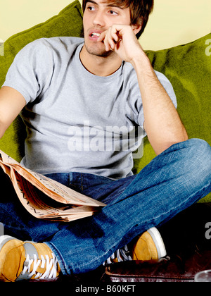 Young Man Reading Newspaper Model Released Stock Photo