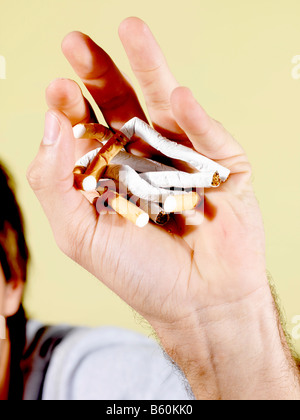 Young Man Breaking Cigarettes Model Released Stock Photo