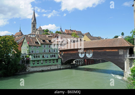 Wooden bridge crossing the Limmat River towards the historic city centre and a church in Baden, Aargau, Switzerland, Europe Stock Photo