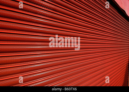 red metal shutter security door on a shop front Stock Photo